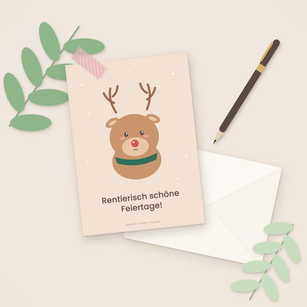 Weihnachtskarte Rentier auf dem Schreibtisch mit Stift