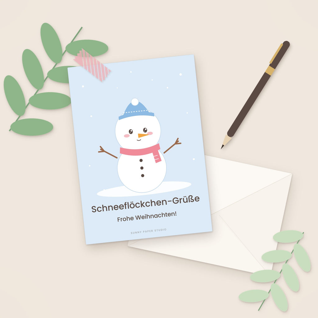 Weihnachtskarte Schneemann auf dem Schreibtisch mit Stift